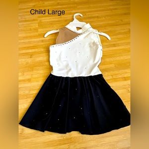 Large rhinestones on white and black heavy fabric figure skating dress.
